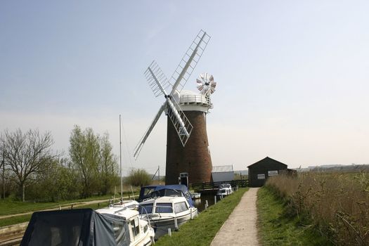 windmill and boats set against the sky line