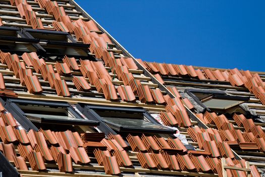 Red tile roof repair or construction work in progress