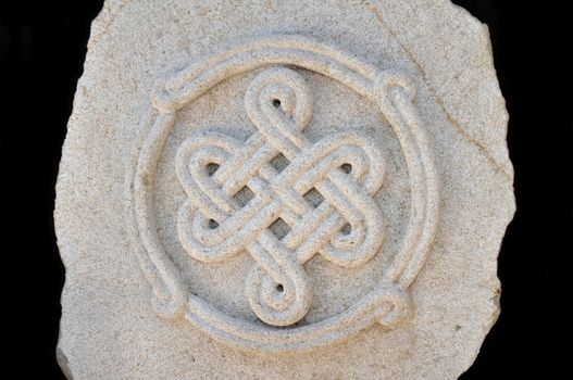 Sculptured symbol decoration on a stone