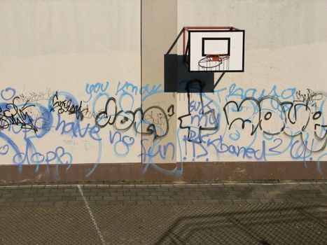 basketball basket on a wall with graffiti