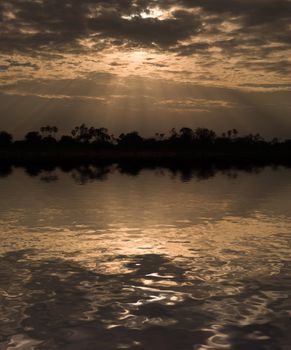 Morning sun rays through clouds in Samburu Reserve, Kenya