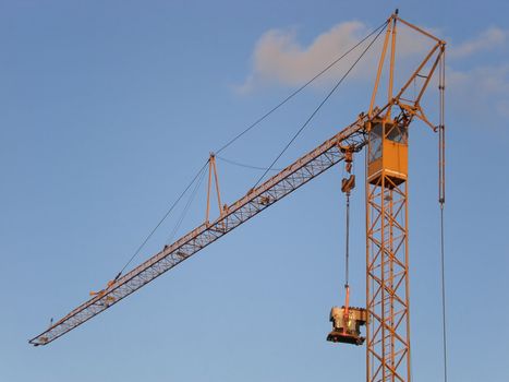 orange colored crane with blue sky