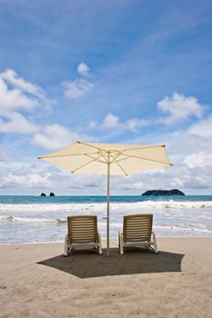 Two chairs and umbrella at the beach. Manuel Antonio, Costa Rica.