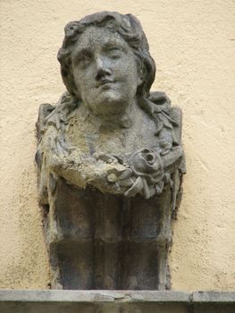 stone lady head sculpture, building detail