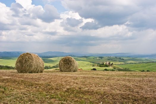 Hay bales on rural landscape. Tuscany, Italy