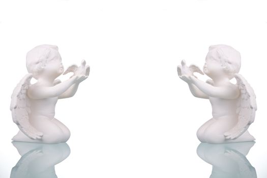 Two angel figures on white background.