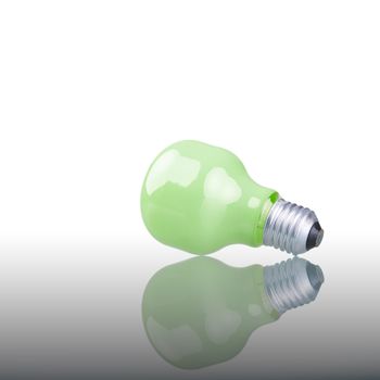 Green bulb with reflection. Studio shot. Concept: ideas.
