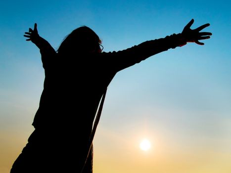 Girl hoping to have the whole world to herself, embracing freedom concept.