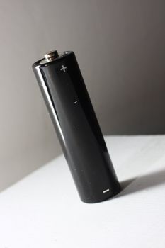 Black AA battery on white background