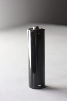 Black AA battery on white background