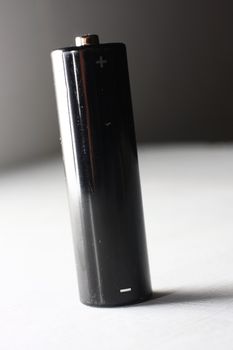 Black AA battery on white background