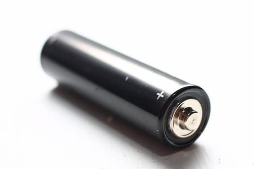 Black AA battery on white background