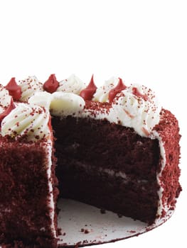 Red velvet cake with a slice missing isolated on a white background