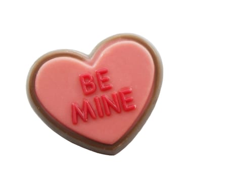 Be mine on a small candy heart isolated on white