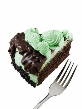 Slice of mint chocolate cake with a fork isolated on white