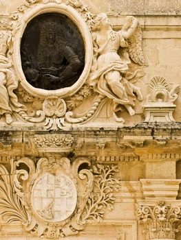 A medieval limestone facade in traditional baroque style in Mdina on the island of Malta