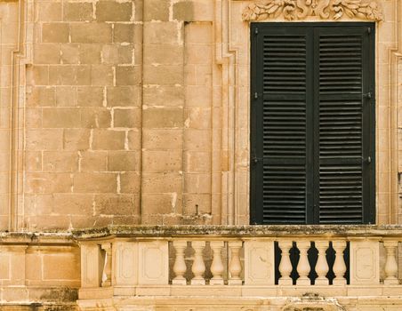 A medieval limestone facade in traditional baroque style in Mdina on the island of Malta