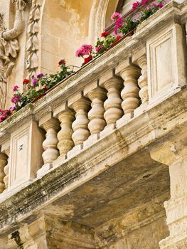 A medieval limestone facade in traditional baroque style in Mdina on the island of Malta