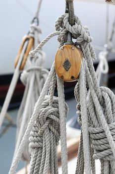 Detail of wooden blocks with ropes on a classical sailboat