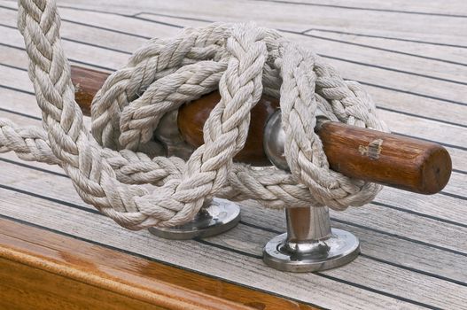 Rope fast to a cleat on a wooden boat