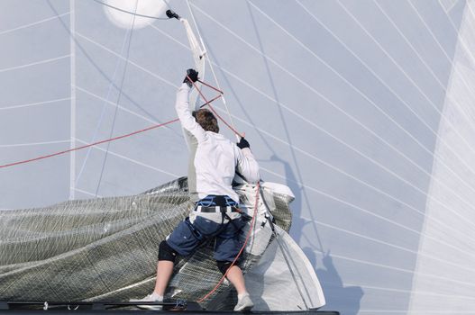 Bowman working on a sailboat