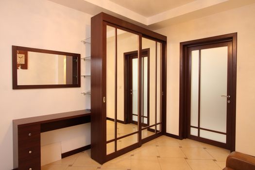 Vestibule with a mirror case, a mirror and a door