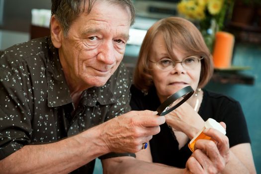 Senior couple closely examining instructions on prescription medications