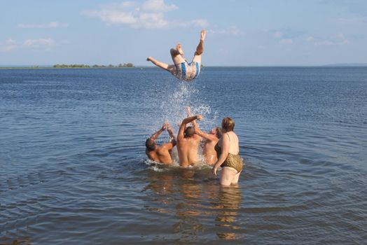 photo of the person jumping with heights in water