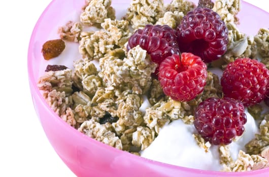 Close up of a bowl filled with curds, cereal and fresh raspberries.