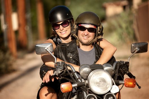 Man and Woman riding on vintage motorcyle