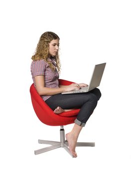 Girl in a armchair with a computer