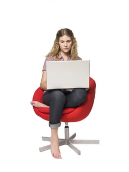 Girl in a armchair with a computer