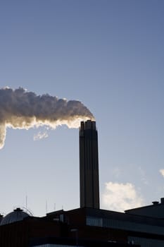 Smoking chimney against a blue sky