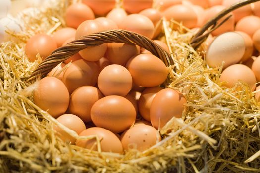 Fresh tiled eggs in baskets on market stall.