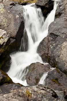 Small mountain waterfall in Pyrenees Andora. Summer time.