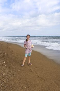 Girl 12 years with stones at sea 
