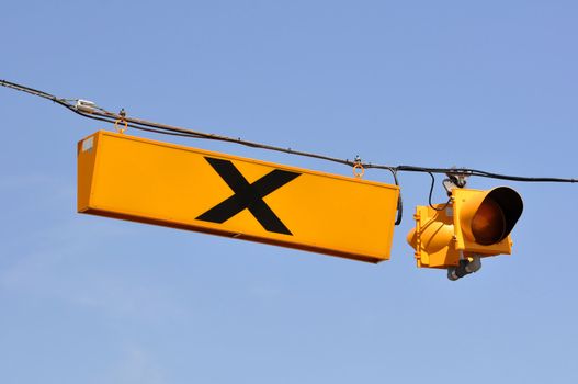 Yellow railroad crossing sign and traffic light