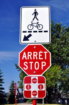 Bilingual English French stop and pedestrian crossing sign