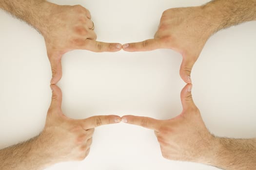 Two sets of Human hands are creating a rectangel frame