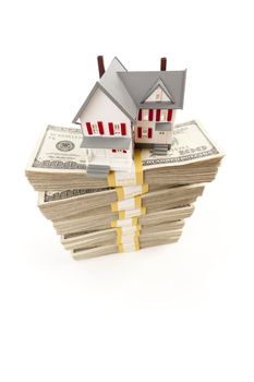 Small House on Stacks of Hundred Dollar Bills Isolated on a White Background.