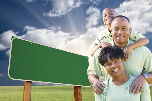 Attractive African American Family in Front of Blank Green Road Sign Ready for Your Own Message.