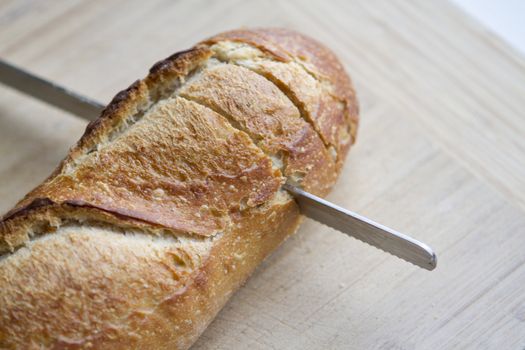 Cut in half Italian Bread. Shallow Depth of field on the cutting board.