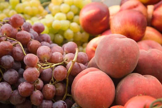 Grapes and peaches on a market stall