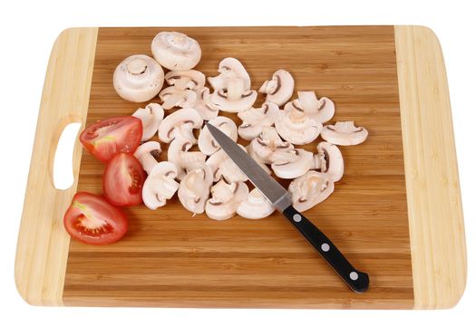 mushrooms to cut on brown chopping board                                 