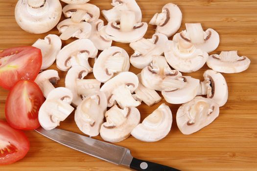 mushrooms to cut on brown chopping board                               