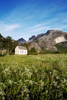 A house in rural Norway at the foot of a mountain