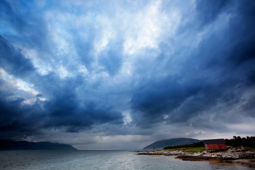 A brewing storm on an ocean sunset