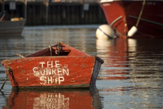 A small red boat at sunset in Nantucket, MA