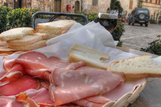 Cold meat and cheese with a glass of wine in Tuscany, Italy