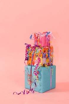colorful stack of birthday presents on pink